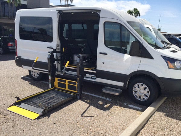 Non-emergency medical transportation wheelchair van in a parking lot.